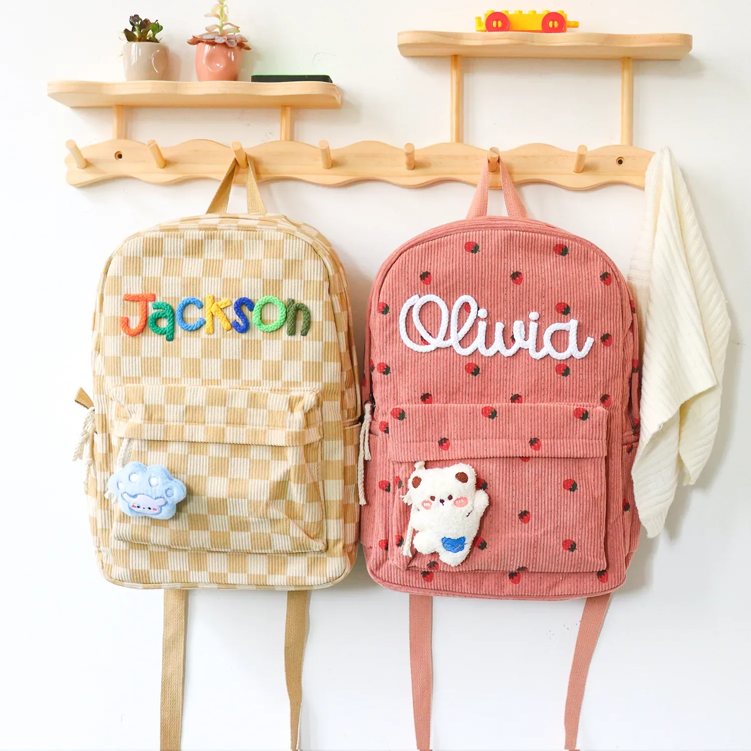 Two personalized children’s backpacks with the names Jackson and Olivia.