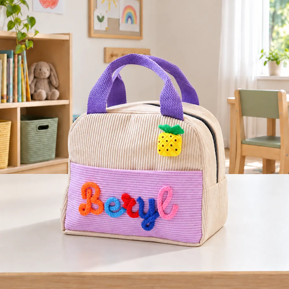 Personalized insulated corduroy lunch bag in beige and lilac with raised yarn name lettering.